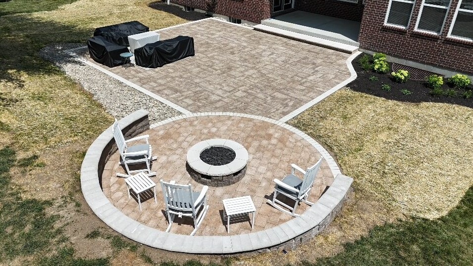 aerial view of stone firepit and patio